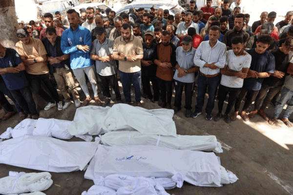Un grupo de dolientes reza en el hospital Al-Shifa, en Gaza, junto a los cuerpos de víctimas de un ataque de Israel contra la escuela Mustafa Hafez, donde se refugian palestinos desplazados por la guerra.