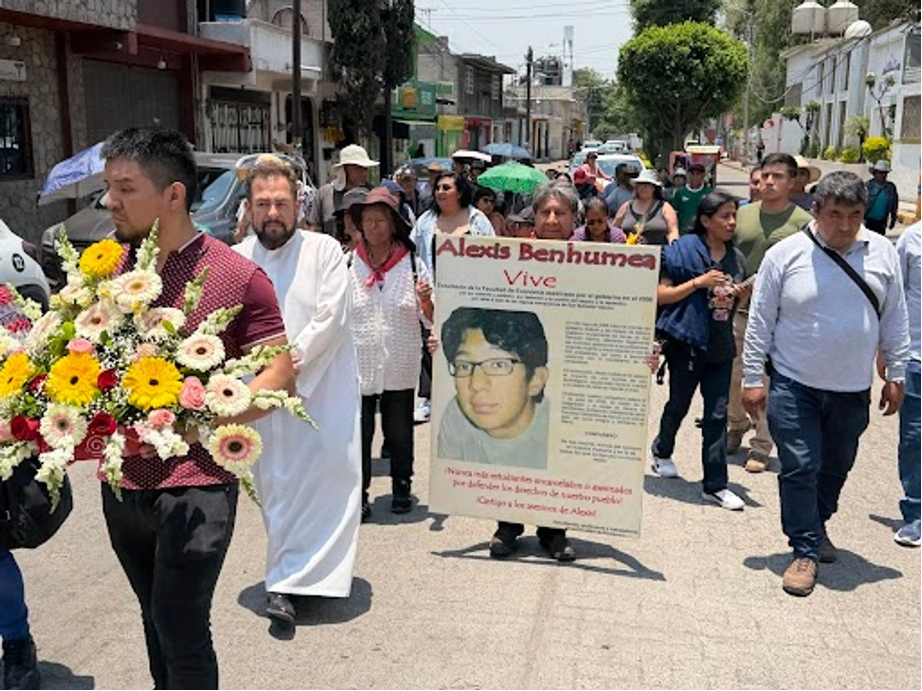 Integrantes del Frente de Pueblos en Defensa de la Tierra, ayer, durante la marcha para conmemorar 20 años de la represión en Atenco, estado de México. En la explanada municipal, el párroco Juan José Castorena ofició una misa.